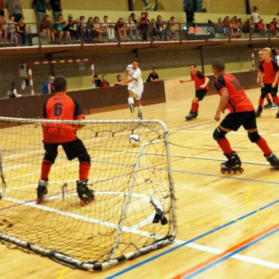RollerSoccer players attacking the goal on inline skates during a club match