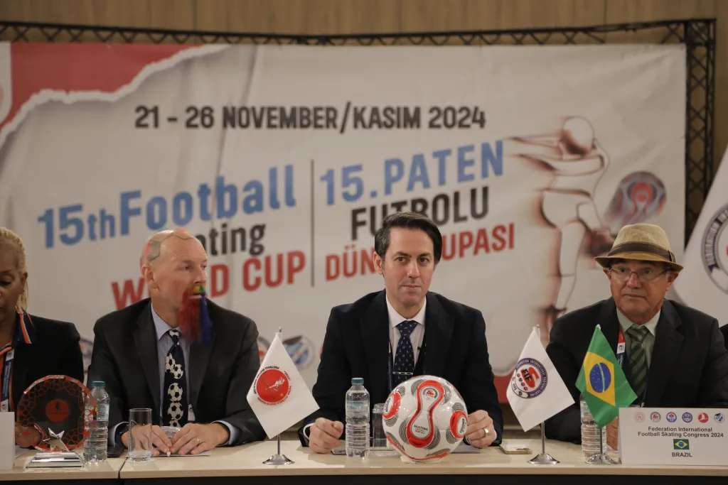 Delegates seated around the FIFS World Congress table in Trabzon, with national flags on the table
