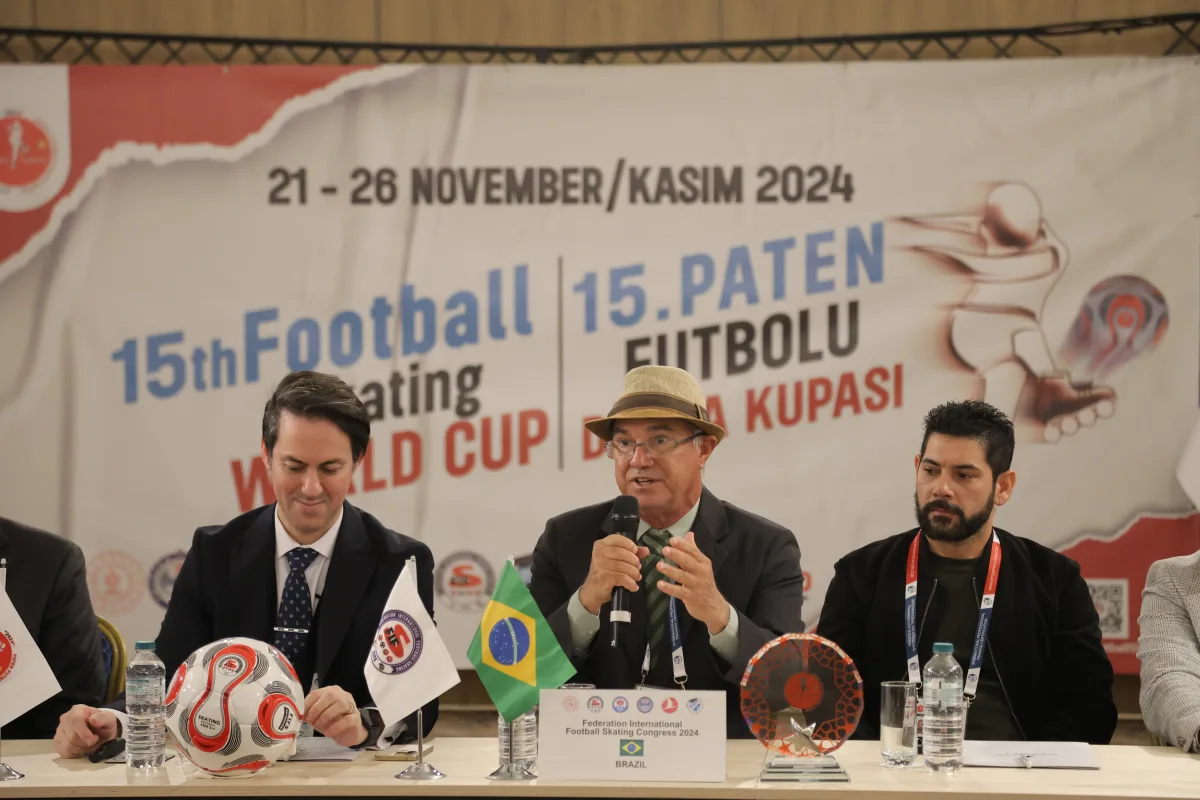 Brazilian representatives addressing the FIFS Congress at the Football Skating World Cup 2024, with the Brazilian flag on the table